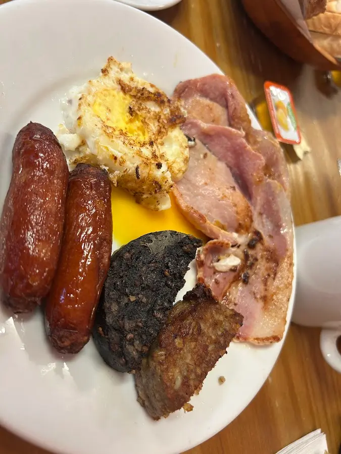 Close-up of Full Irish breakfast with sausage, bacon, egg, and puddings