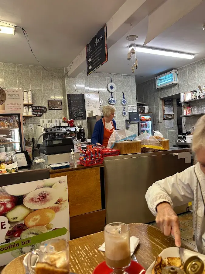 Ann Curtin at the counter with smoothie bar sign and coffee machine
