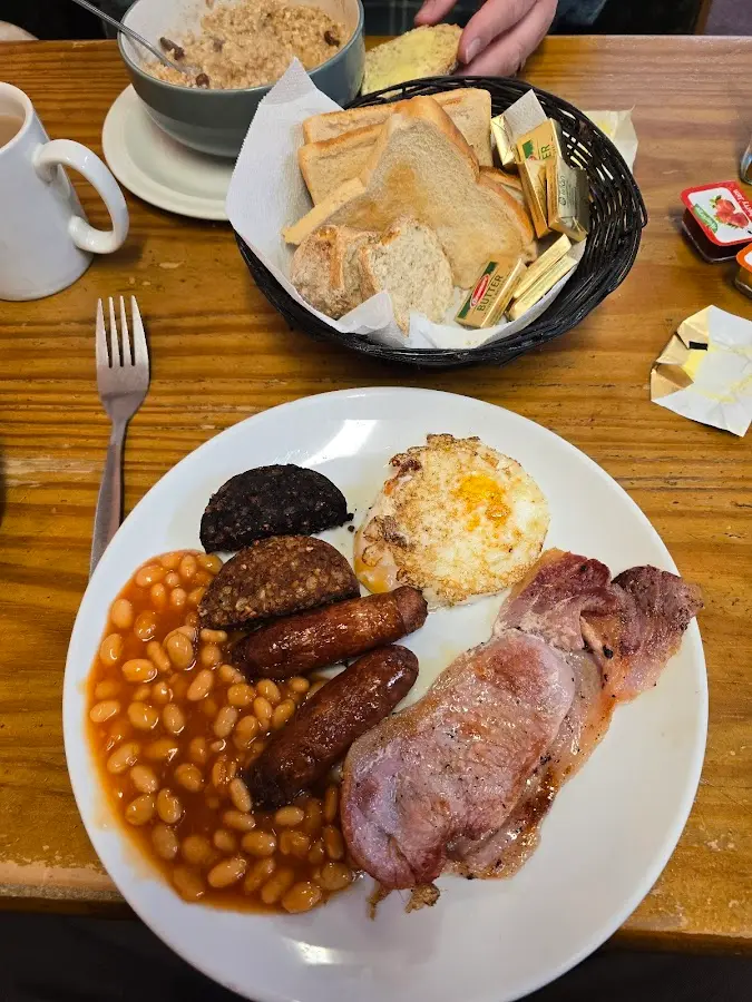 Full Irish breakfast with bacon, sausage, egg, black pudding, beans, and toast